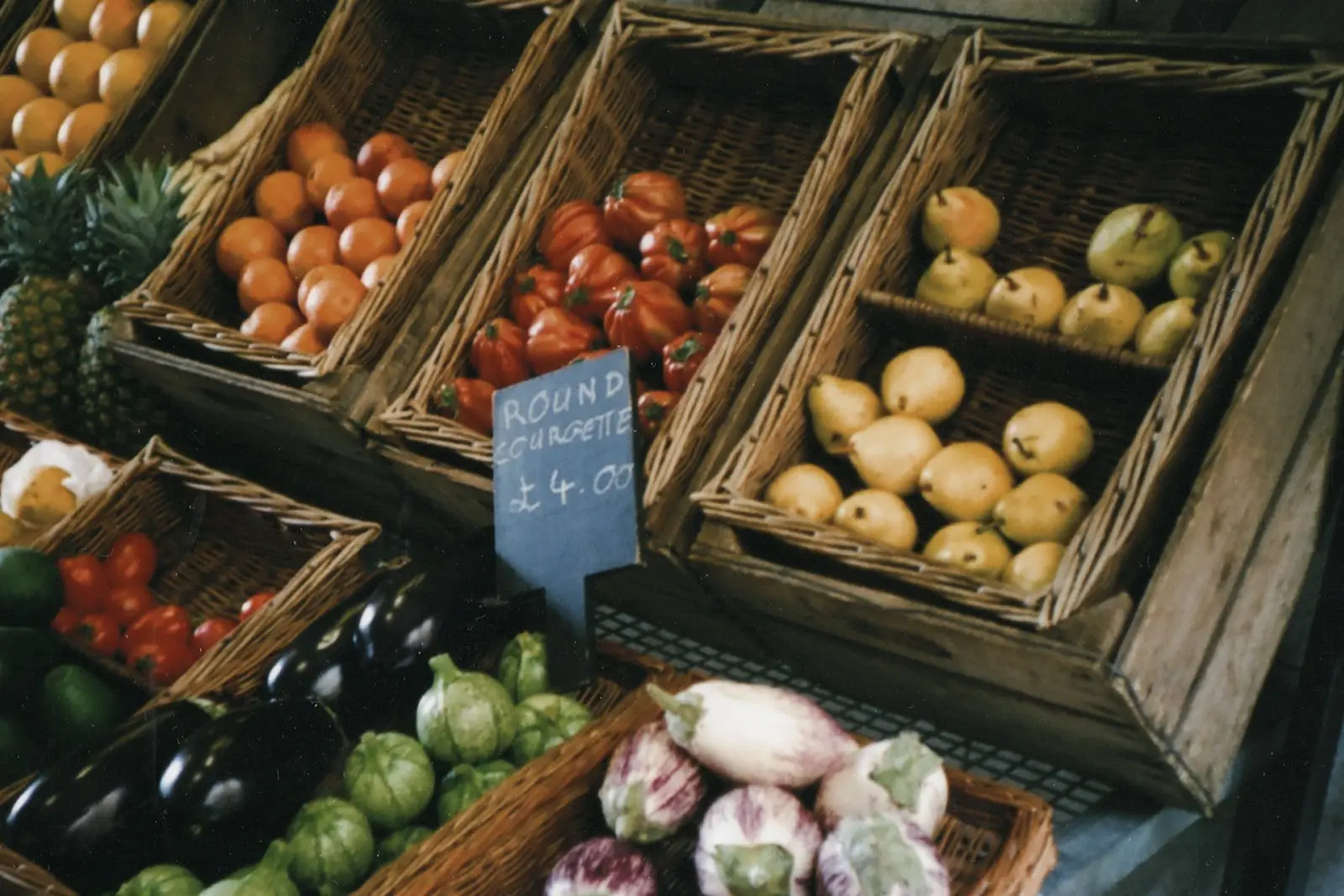Wooden crates of apples, tomatoes and vegetables
